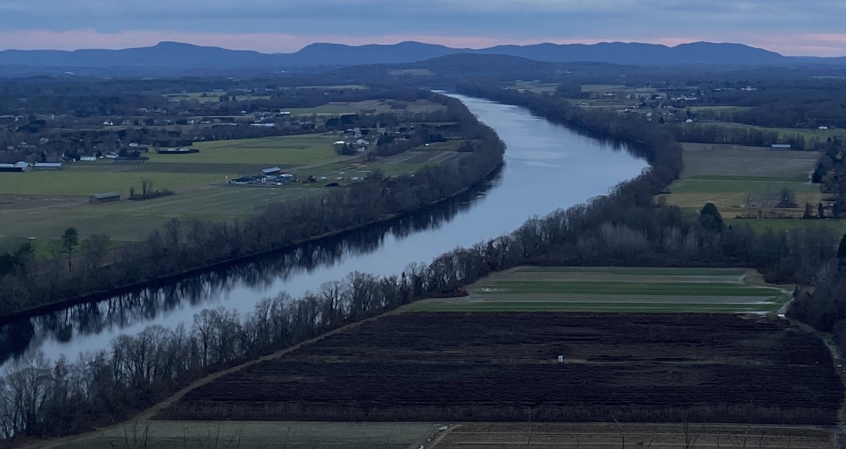 Connecticut River winding through farmland. View is from Mount Sugarloaf in the north, with the Holyoke Range visible in the south.